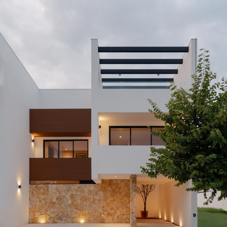 fachada moderna con muros de piedra, color blllanco
