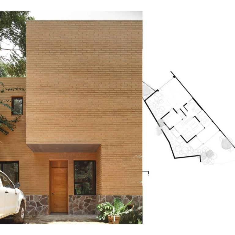 A house with a car parked in front of it.